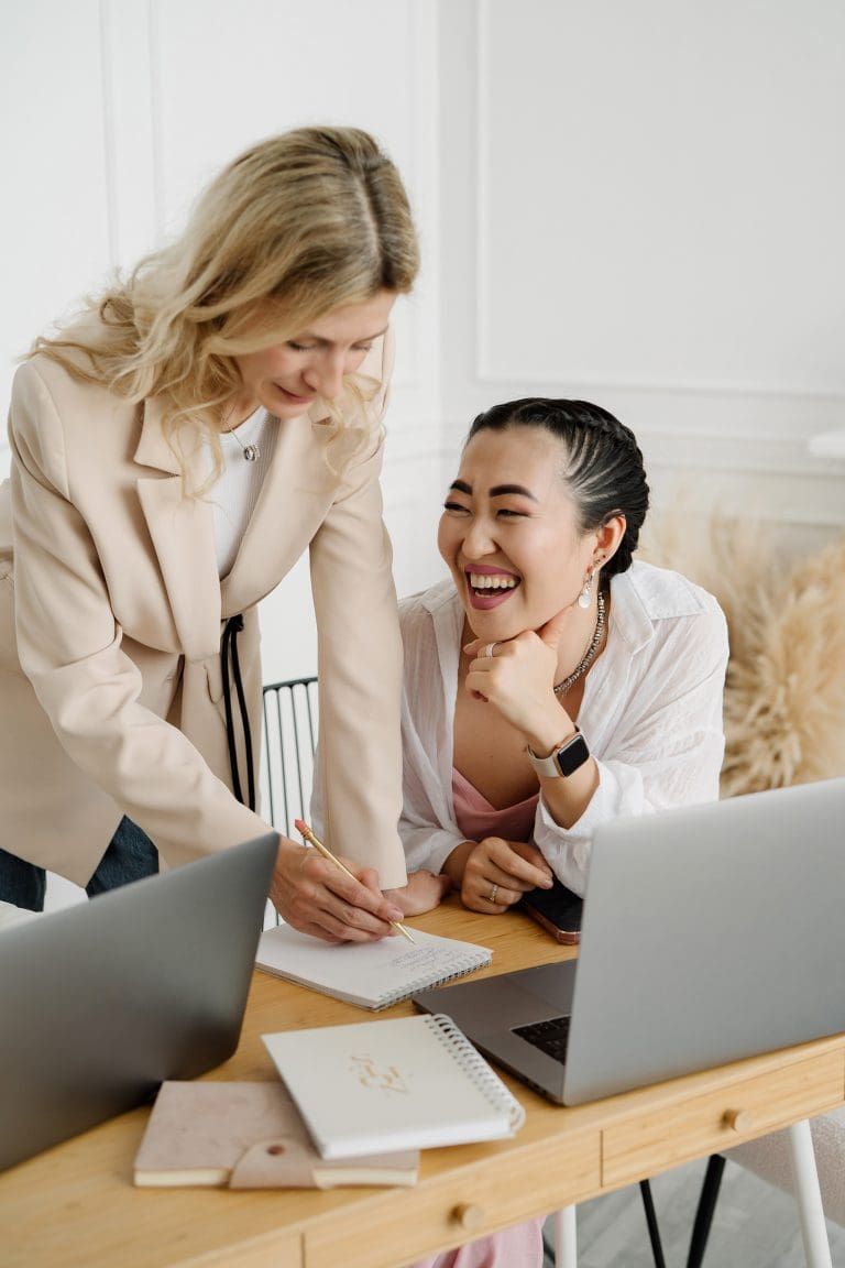 2 women coming together with laughter