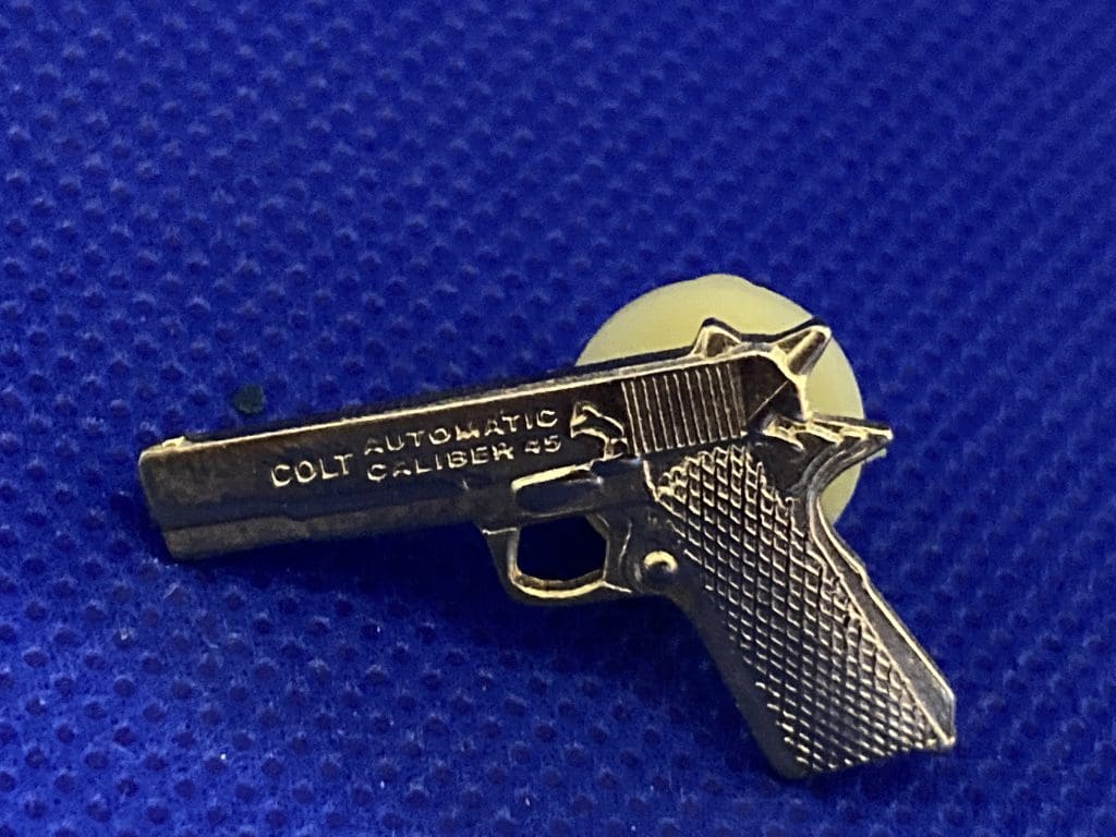 gold toned colt automatic caliber gun lapel pin
