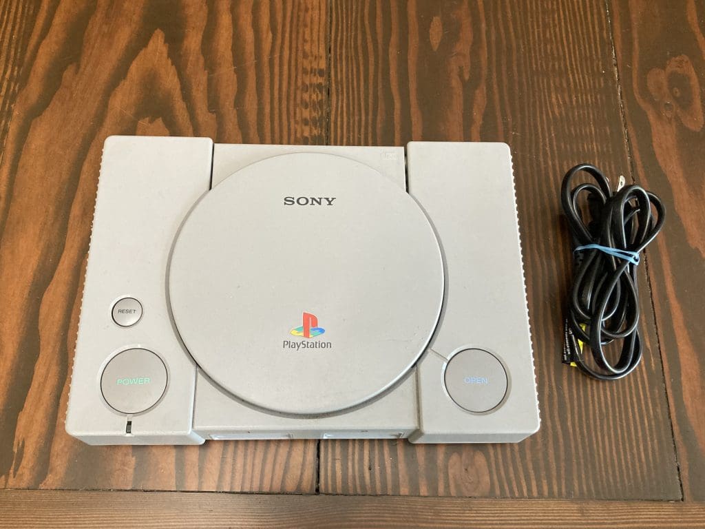 Gray Playstation with cord